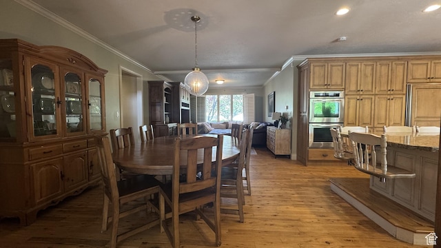 dining space featuring ornamental molding, light wood-type flooring, and recessed lighting