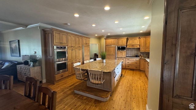 kitchen featuring stainless steel appliances, crown molding, recessed lighting, tasteful backsplash, and light wood-type flooring