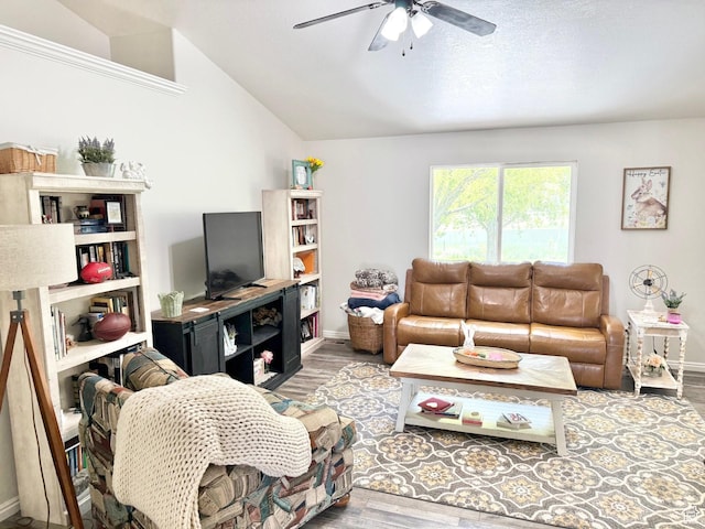 living area with ceiling fan, wood finished floors, lofted ceiling, and baseboards