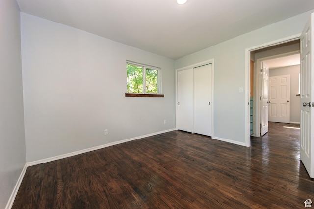4872 S Burch Creek Dr, South Ogden, UT 84403 - unfurnished bedroom with baseboards, dark wood-style floors, and a closet