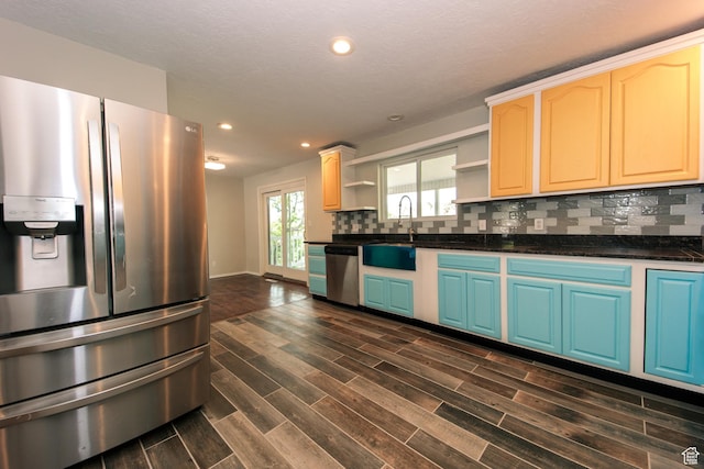 4872 S Burch Creek Dr, South Ogden, UT 84403 - kitchen with stainless steel appliances, a sink, open shelves, dark countertops, and dark wood-style floors