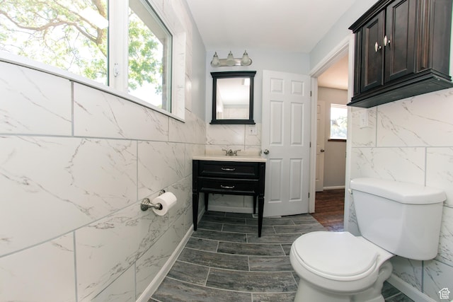 4872 S Burch Creek Dr, South Ogden, UT 84403 - bathroom with tile walls, vanity, toilet, and wood finished floors