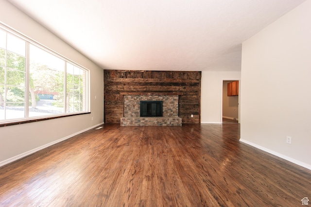 4872 S Burch Creek Dr, South Ogden, UT 84403 - unfurnished living room with wood finished floors, baseboards, and a large fireplace