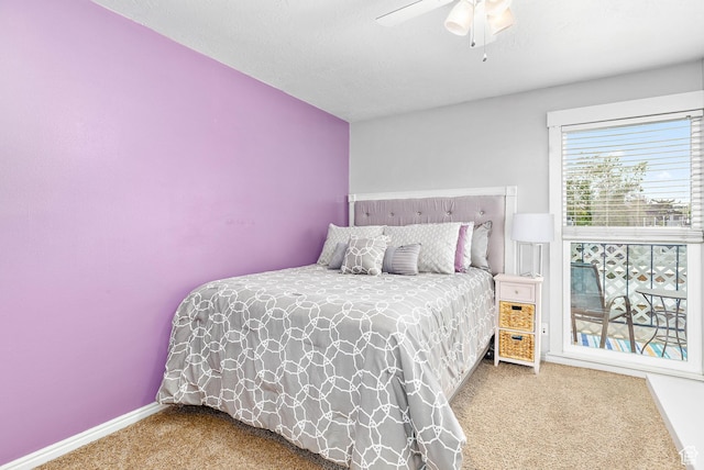 carpeted bedroom featuring ceiling fan and baseboards