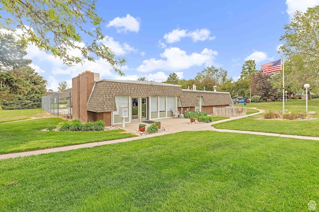 view of front of house with a garage, concrete driveway, brick siding, and mansard roof