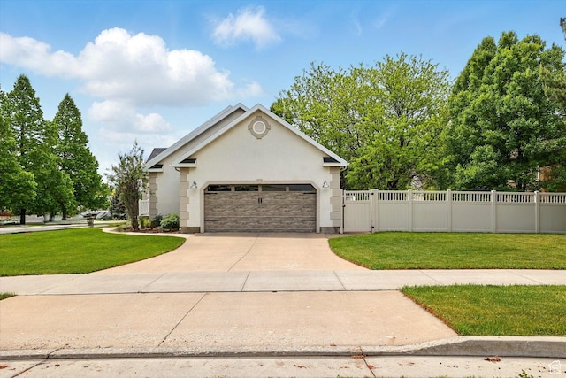 view of front of property with concrete driveway, a garage, stucco siding, and a gate