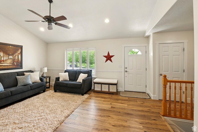 living area featuring lofted ceiling, wood finished floors, a ceiling fan, and recessed lighting