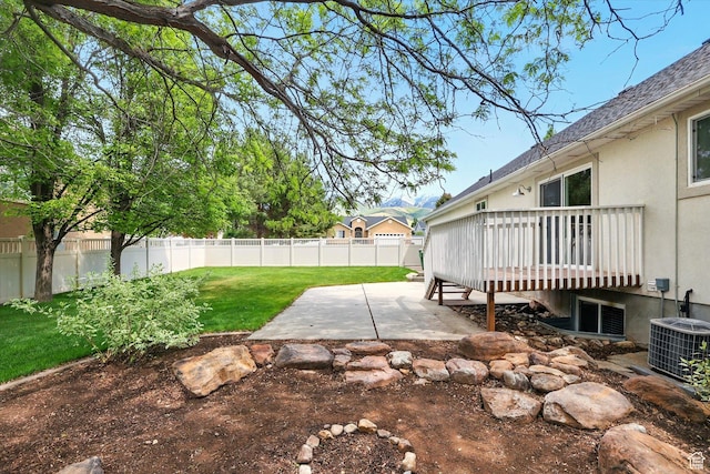 view of yard with a patio, a deck, and central AC