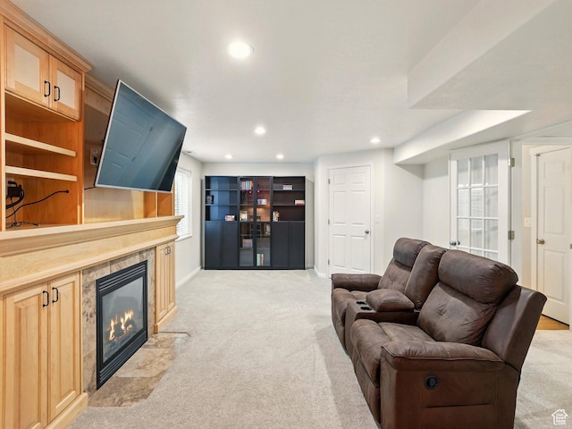 living area featuring light colored carpet, a fireplace, recessed lighting, and baseboards