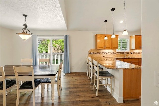 dining space with wood finished floors and baseboards
