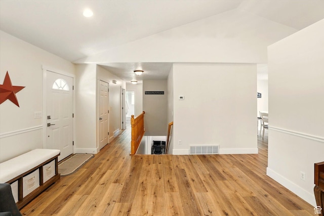 entrance foyer featuring wood finished floors, baseboards, and lofted ceiling