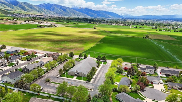 aerial perspective of suburban area with a mountain backdrop and a golf club