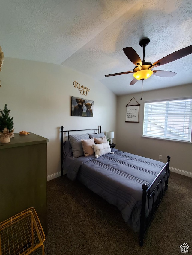 bedroom with dark carpet, a textured ceiling, baseboards, ceiling fan, and vaulted ceiling