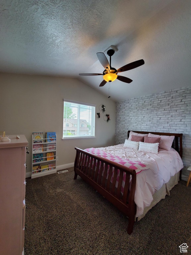bedroom featuring vaulted ceiling, a textured ceiling, carpet floors, baseboards, and a ceiling fan