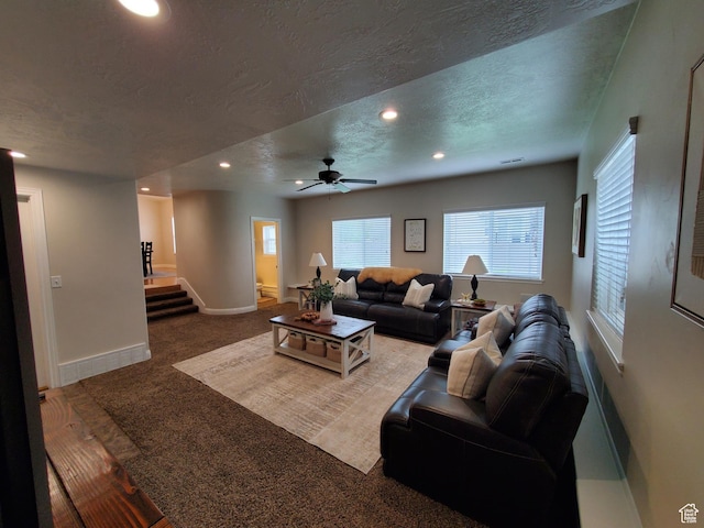 carpeted living room featuring recessed lighting, stairway, a textured ceiling, baseboards, and ceiling fan