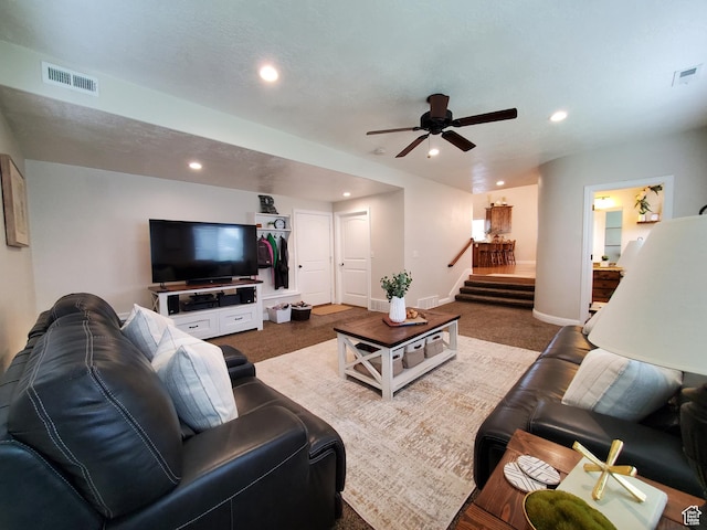 carpeted living area featuring recessed lighting, stairs, ceiling fan, and baseboards