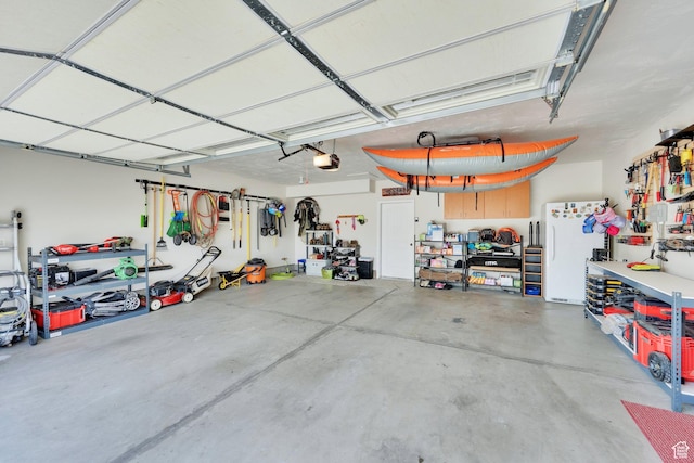 616 W Northlake Dr, Lehi, UT 84043 - garage featuring freestanding refrigerator, a garage door opener, and a workshop area
