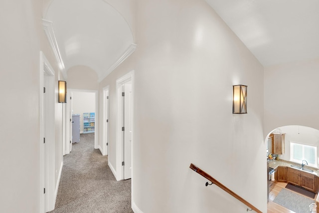 616 W Northlake Dr, Lehi, UT 84043 - hallway with arched walkways, ornamental molding, a sink, vaulted ceiling, and light colored carpet