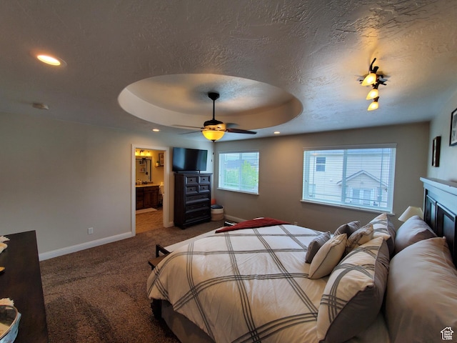 bedroom with baseboards, carpet, a textured ceiling, recessed lighting, and a raised ceiling