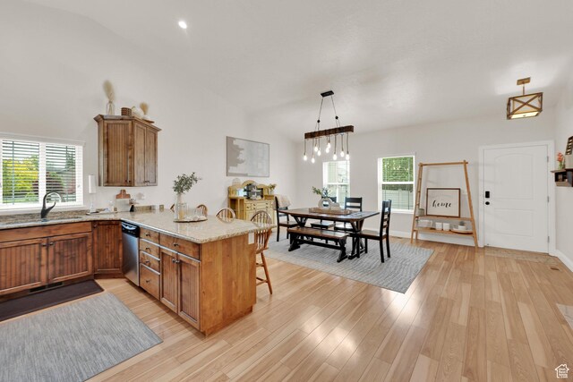 616 W Northlake Dr, Lehi, UT 84043 - kitchen with a sink, brown cabinets, a peninsula, stainless steel dishwasher, and vaulted ceiling