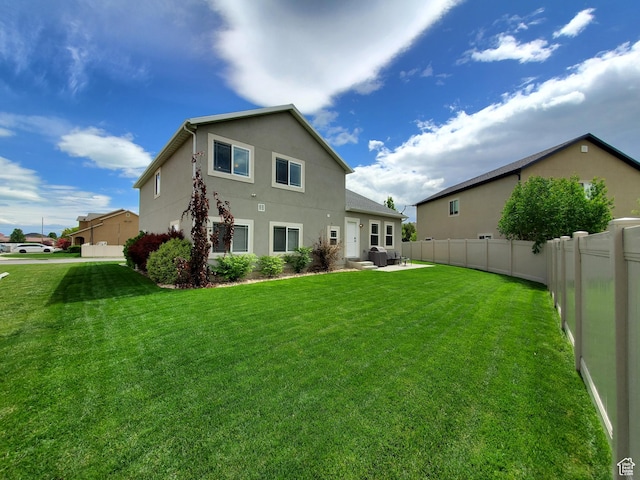 rear view of house featuring stucco siding and a patio