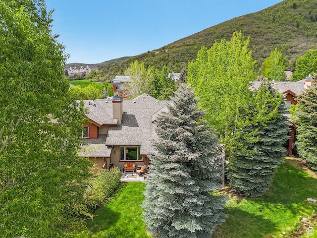 aerial view of property and surrounding area featuring mountains