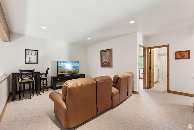 living area with light carpet, recessed lighting, and baseboards
