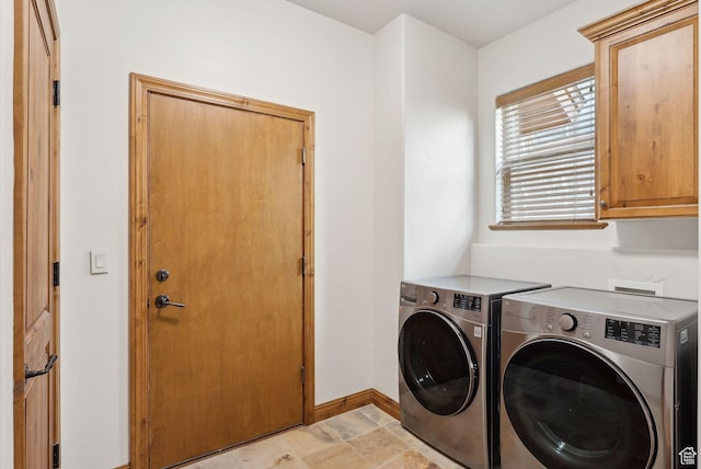 clothes washing area featuring cabinet space, separate washer and dryer, and baseboards