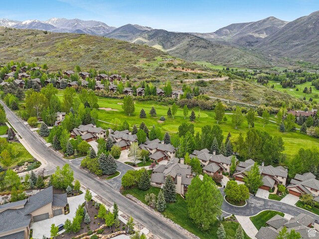 aerial view of property and surrounding area with mountains and nearby suburban area