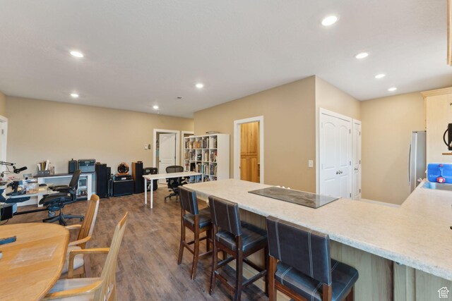 8819 Highfield Rd Unit 61, Park City, UT 84098 - kitchen featuring recessed lighting, a peninsula, dark wood-type flooring, black electric stovetop, and a breakfast bar area