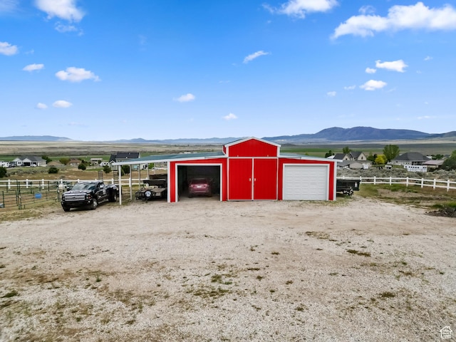 2521 W Ridgeline Rd, Stockton, UT 84071 - garage with fence, a mountain view, and a garage