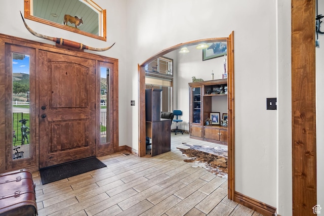 2521 W Ridgeline Rd, Stockton, UT 84071 - foyer with arched walkways, wood tiled floors, and healthy amount of natural light