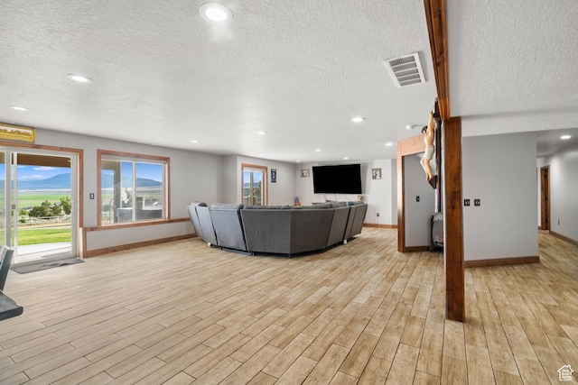 2521 W Ridgeline Rd, Stockton, UT 84071 - living room with a textured ceiling, baseboards, light wood finished floors, and recessed lighting