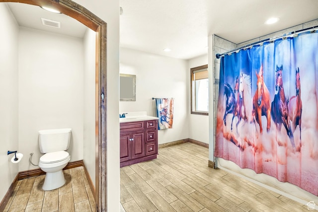 2521 W Ridgeline Rd, Stockton, UT 84071 - bathroom with wood finish floors, baseboards, toilet, a shower with shower curtain, and vanity