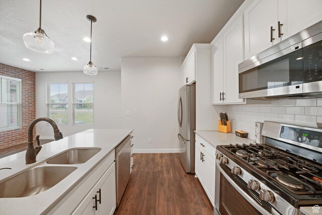 11413 S Kitty Hawk Rd W, South Jordan, UT 84009 - kitchen featuring stainless steel appliances, a sink, decorative backsplash, dark wood-style floors, and hanging light fixtures