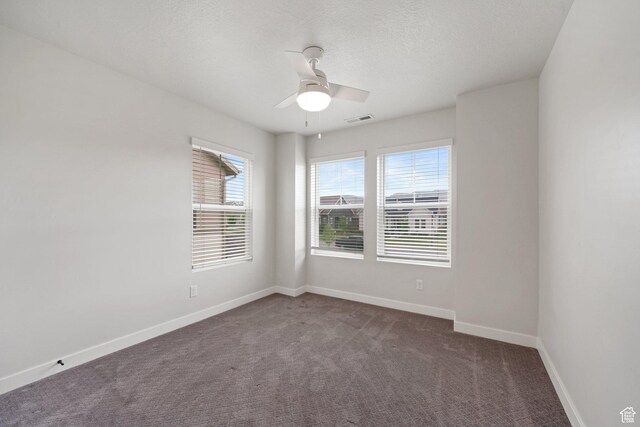 11413 S Kitty Hawk Rd W, South Jordan, UT 84009 - spare room featuring dark carpet, a ceiling fan, baseboards, and a textured ceiling