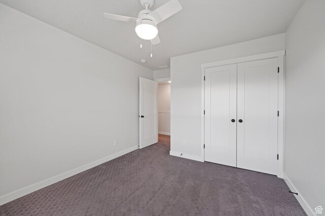 11413 S Kitty Hawk Rd W, South Jordan, UT 84009 - unfurnished bedroom with dark colored carpet, baseboards, a closet, and a ceiling fan