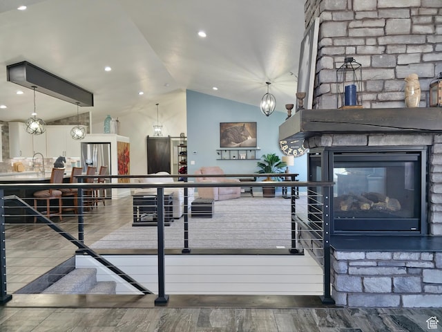 123 Red Hawk Ave, Evanston, WY 82930 - living area with lofted ceiling, wood finished floors, and a fireplace