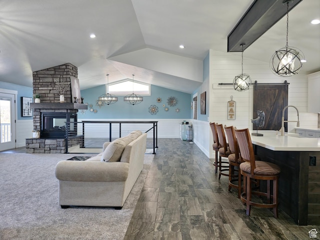 123 Red Hawk Ave, Evanston, WY 82930 - living area with lofted ceiling, a barn door, dark wood finished floors, wainscoting, and a chandelier
