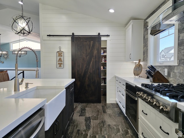 123 Red Hawk Ave, Evanston, WY 82930 - kitchen featuring stainless steel appliances, lofted ceiling, a sink, a barn door, and white cabinets