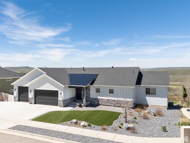 123 Red Hawk Ave, Evanston, WY 82930 - view of front of home featuring a garage, board and batten siding, a front yard, and a shingled roof