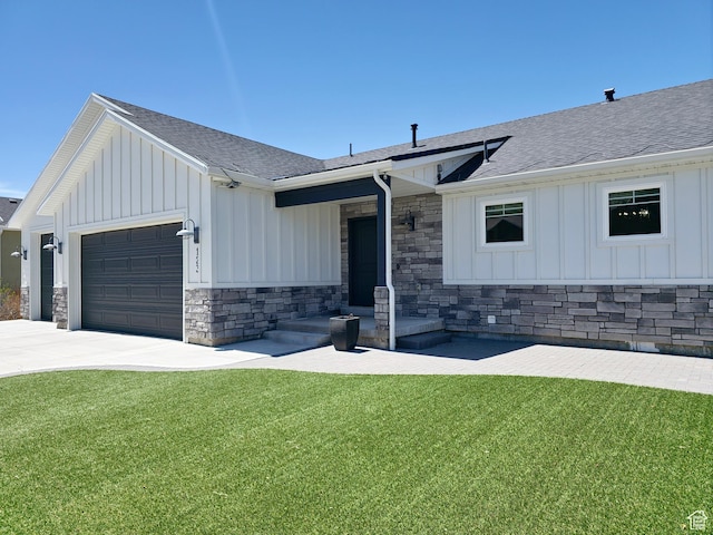 123 Red Hawk Ave, Evanston, WY 82930 - modern farmhouse style home featuring board and batten siding, stone siding, a shingled roof, a front lawn, and a garage