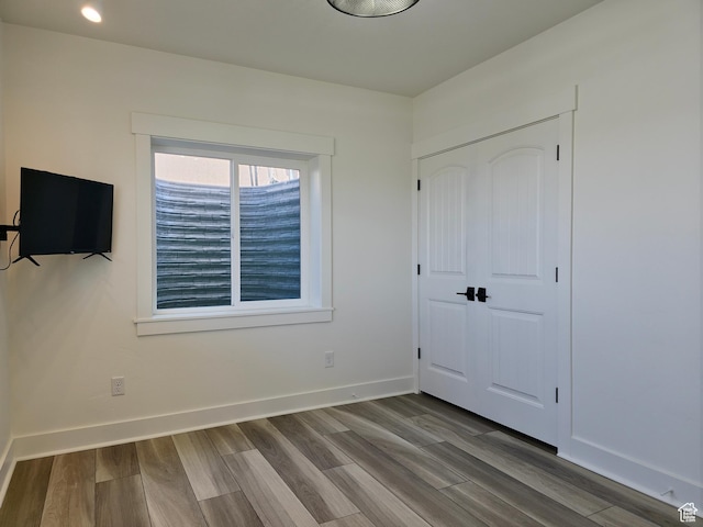 123 Red Hawk Ave, Evanston, WY 82930 - unfurnished bedroom with wood finished floors, a closet, and baseboards