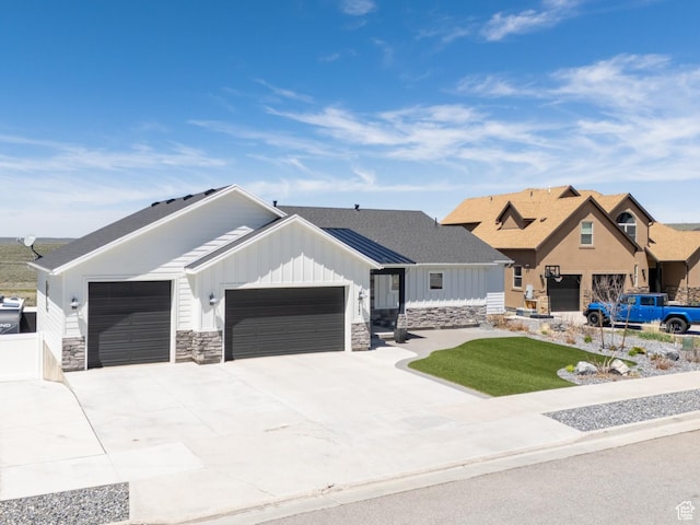 123 Red Hawk Ave, Evanston, WY 82930 - view of front of home with a garage, board and batten siding, stone siding, and concrete driveway