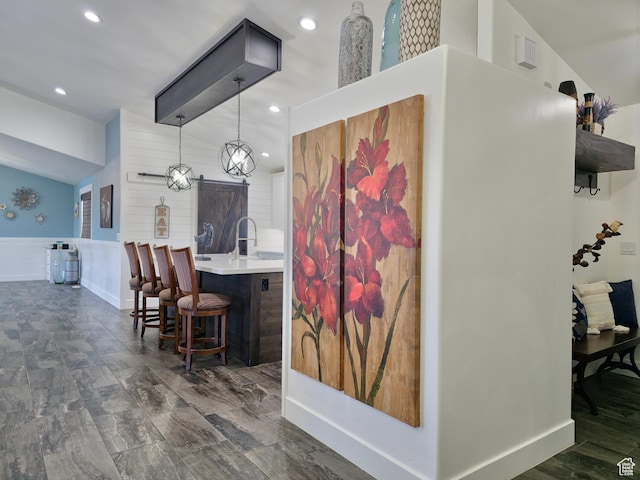 123 Red Hawk Ave, Evanston, WY 82930 - kitchen featuring wainscoting, light countertops, a kitchen breakfast bar, recessed lighting, and decorative light fixtures