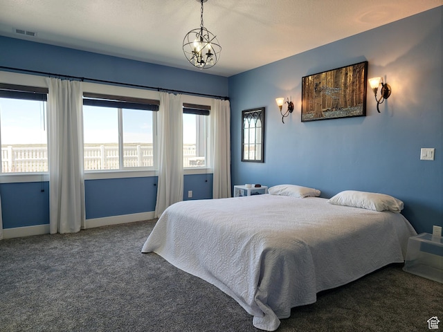 123 Red Hawk Ave, Evanston, WY 82930 - carpeted bedroom featuring baseboards and a chandelier
