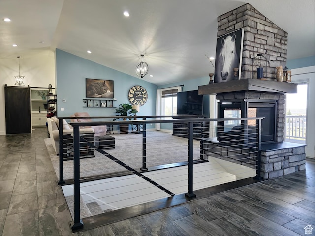 123 Red Hawk Ave, Evanston, WY 82930 - interior space with lofted ceiling, a stone fireplace, wood finished floors, and recessed lighting