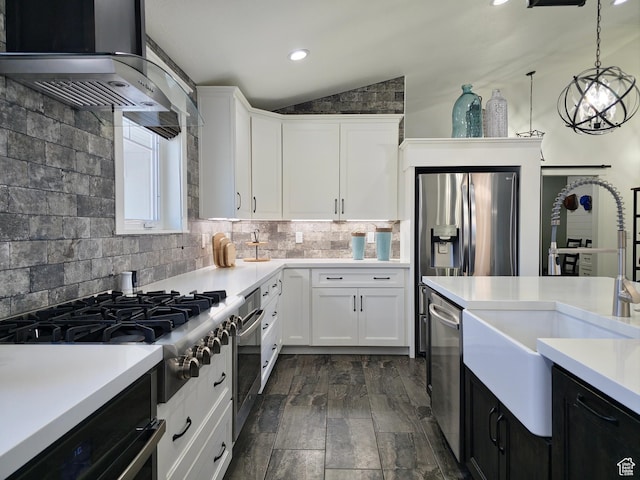 123 Red Hawk Ave, Evanston, WY 82930 - kitchen featuring ventilation hood, vaulted ceiling, appliances with stainless steel finishes, light countertops, and white cabinets