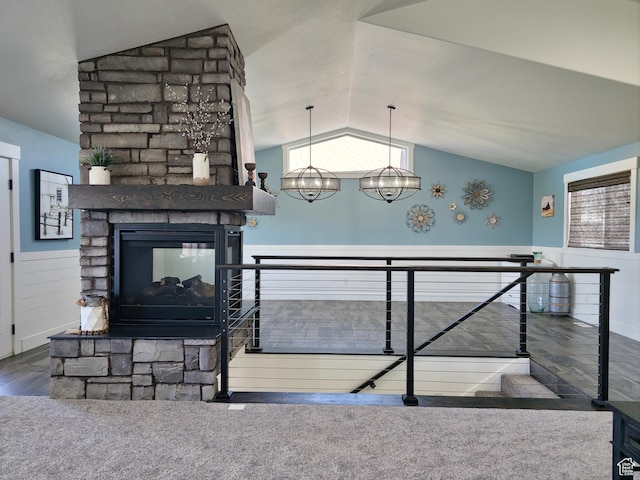 123 Red Hawk Ave, Evanston, WY 82930 - living room featuring vaulted ceiling, a multi sided fireplace, and wood finished floors