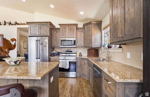 3017 W Ridgeline Rd, Stockton, UT 84071 - kitchen with appliances with stainless steel finishes, a sink, lofted ceiling, wood finished floors, and light stone counters